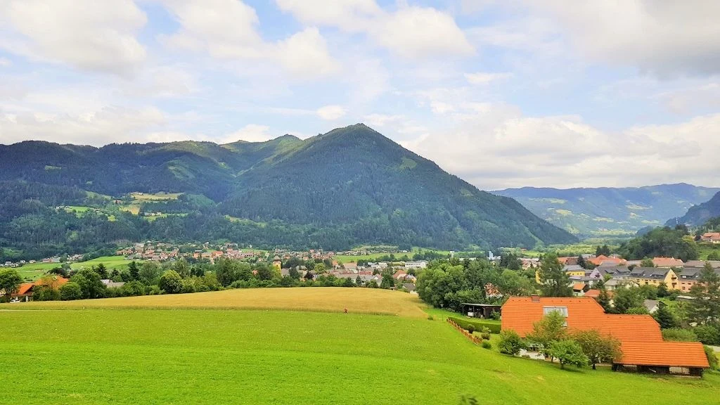 Travelling through the stunning countryside of Styria in Austria on a train heading to Venice