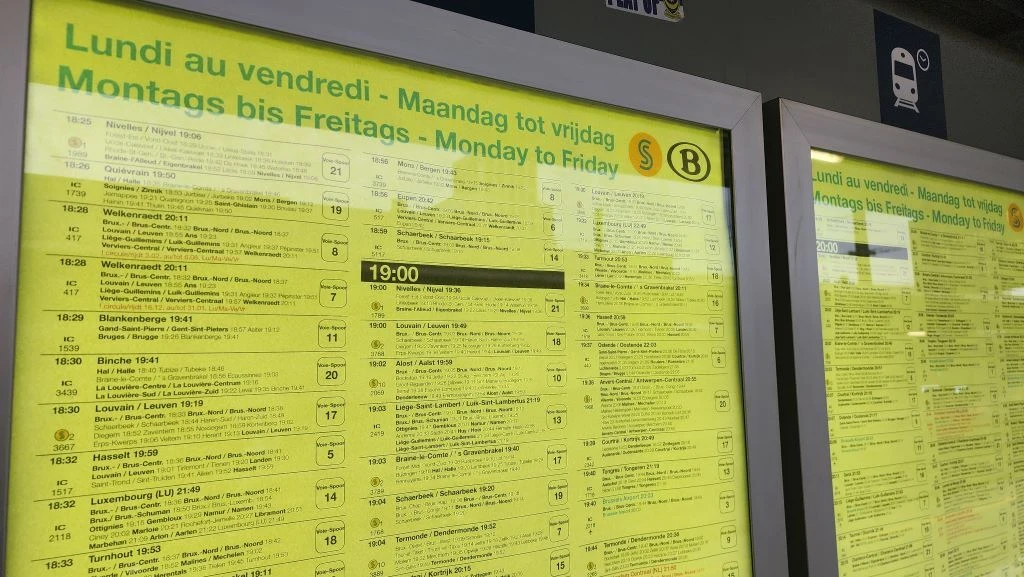 Checking the train departure posters at Bruxelles-Midi station